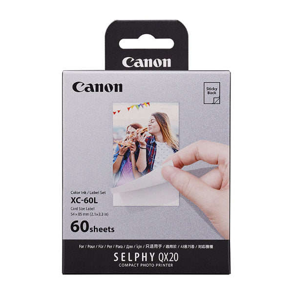 Canon photo paper packaging with a hand holding a printed photo on a white background