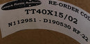 Close-up of a label with text and a logo on a cardboard background